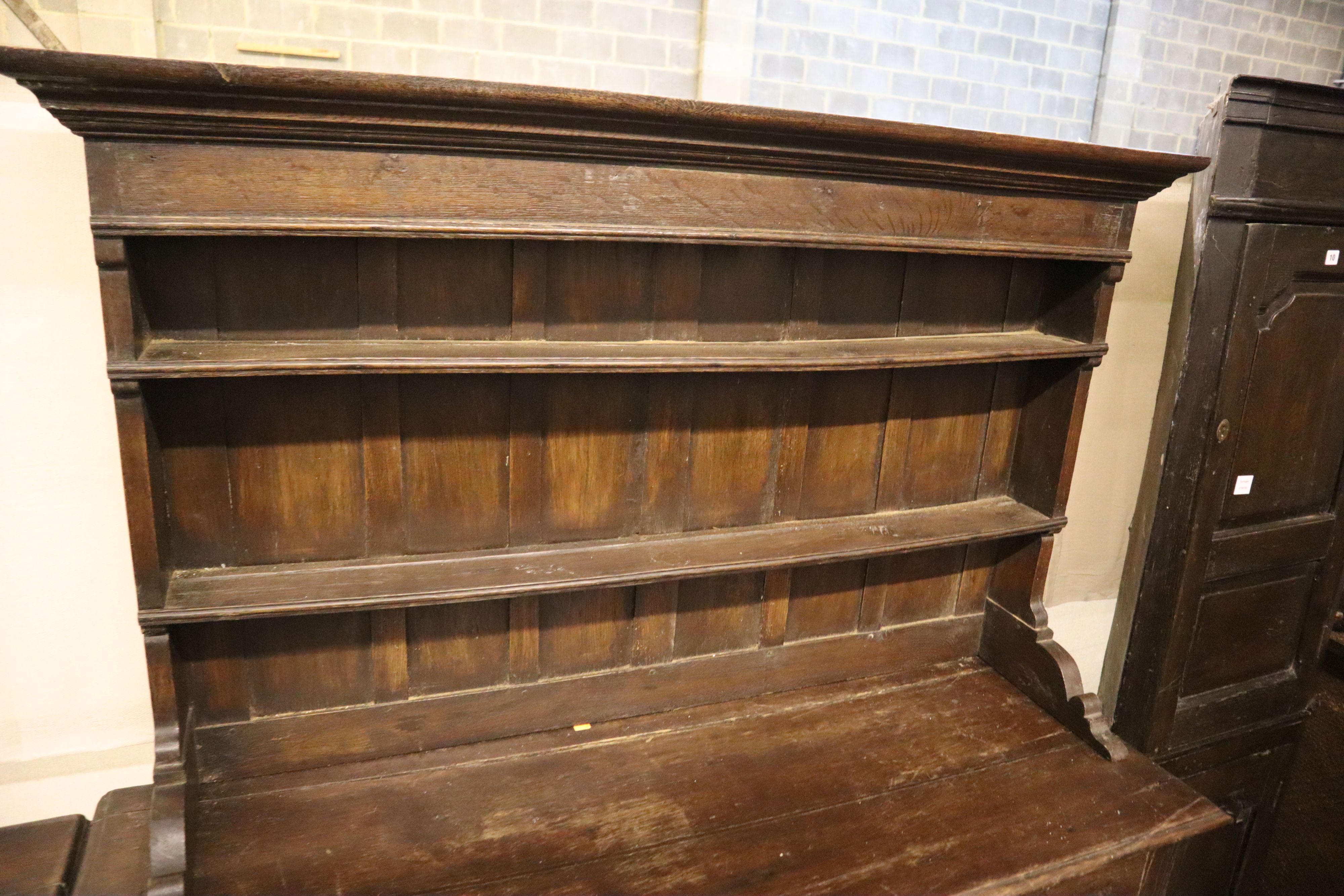 An 18th century oak mule chest with associated rack, width 151cm, depth 54cm, height 180cm